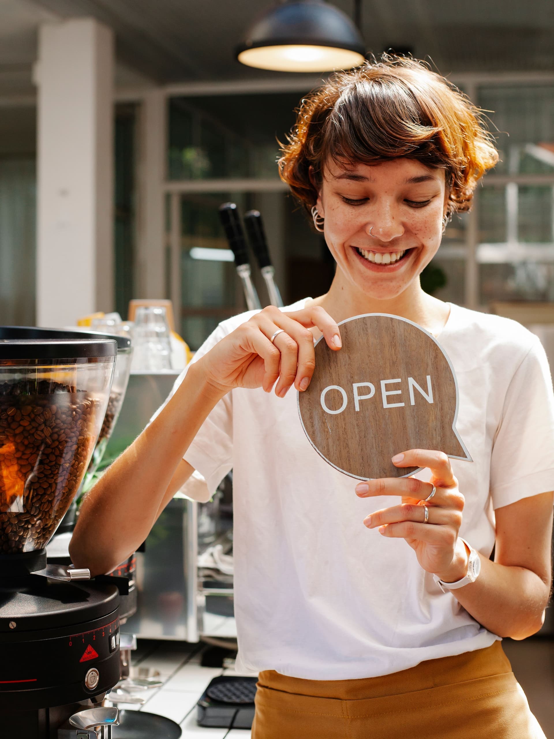 Local food and beverage business owner turning the sign to OPEN