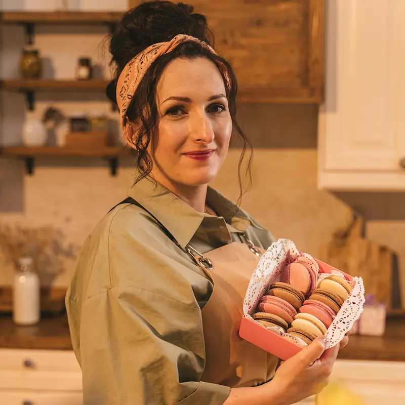 Baker holding a tray of fresh pastries
