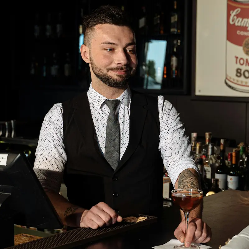 Bartender behind the bar