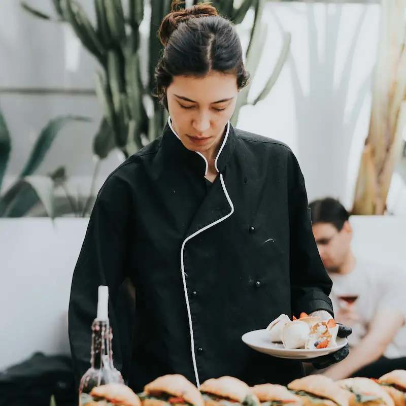 Caterer plating food at an off-site event