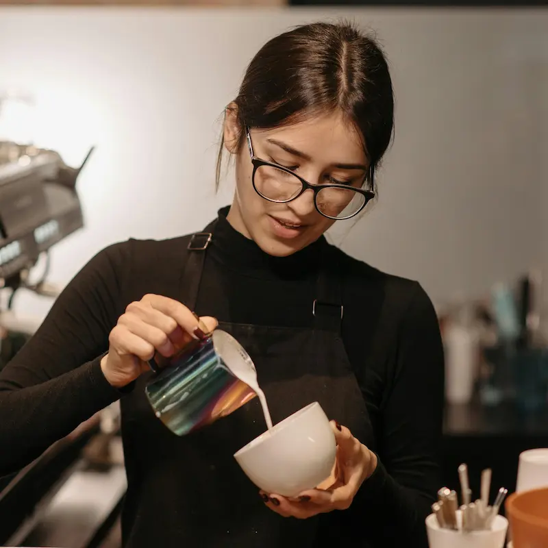 Coffee shop barista at the espresso machine